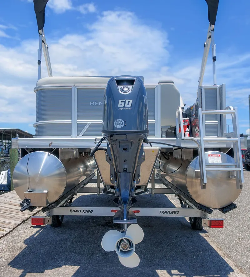 Slide: The Image of A 2027 Bennington 18 S CRUISE pontoon boat with a 60 HP outboard motor, on a trailer. - 3