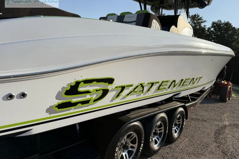 Slide: The Image of 2017 Statement 380 Open boat on trailer, featuring bold green and black graphics. - 4