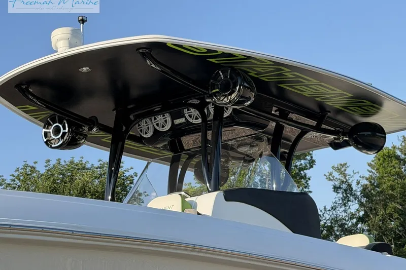 Slide: The Image of 2017 Statement 380 Open boat with sleek black T-top and speakers. - 11