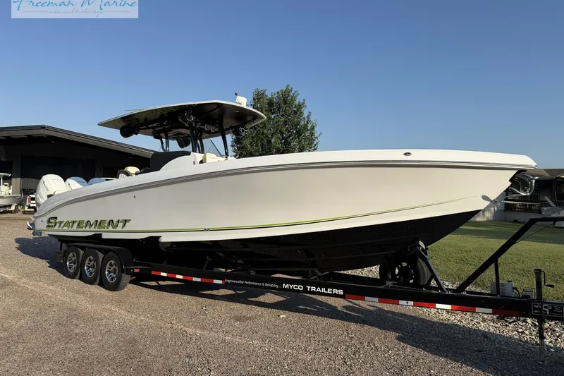 Slide: The Image of 2017 Statement 380 Open boat on trailer, displayed outdoors under clear sky. - 3