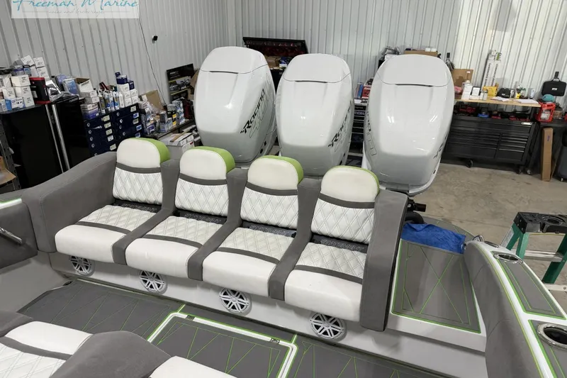 Slide: The Image of Luxury seating and powerful engines on a 2017 Statement 380 Open boat in a workshop. - 23