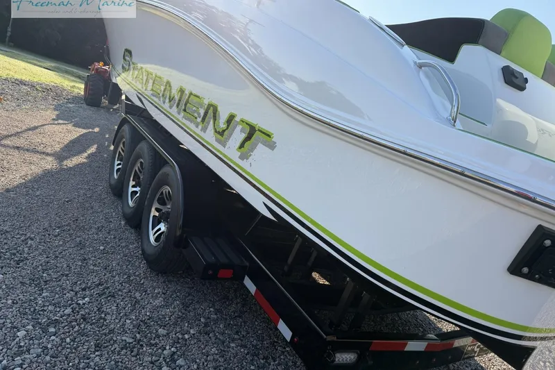 Slide: The Image of 2017 Statement 380 Open boat on trailer, featuring sleek design and triple-axle wheels. - 6