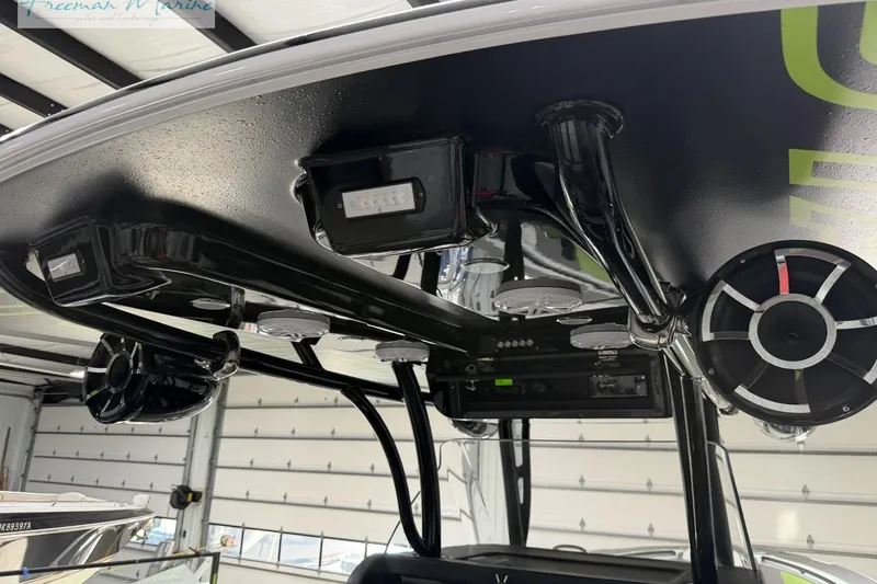 Slide: The Image of 2017 Statement 380 Open boat interior with speakers and lighting in a garage setting. - 21