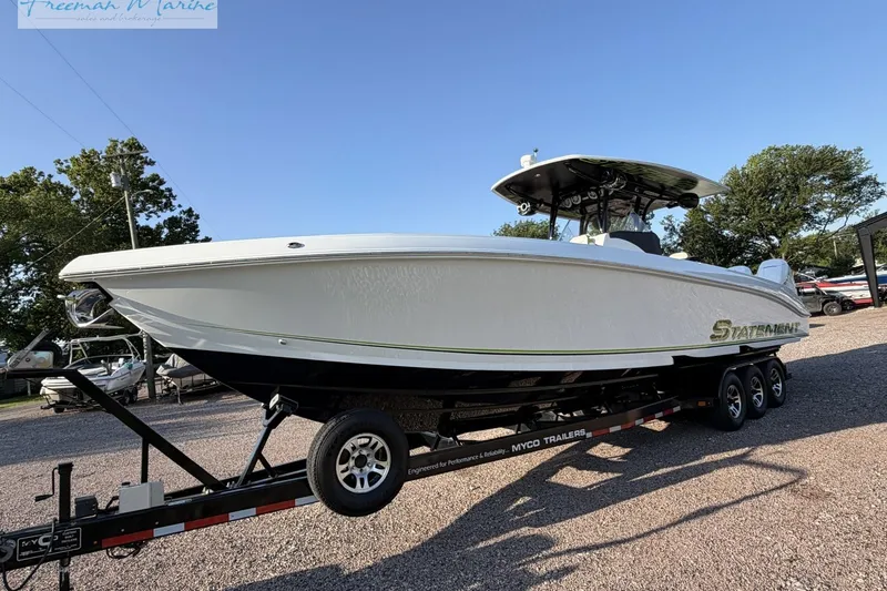 Slide: The Image of 2017 Statement 380 Open boat on trailer, displayed outdoors under clear sky. - 10
