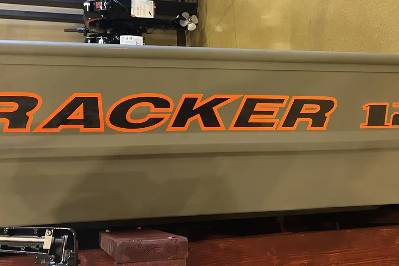 The Image of 2026 Tracker Grizzly 12 Jon boat with bold orange lettering on the side. - 0