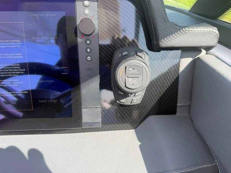 Slide: The Image of Close-up of a boat control system with a display and controls. - 32