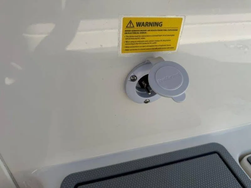 Slide: The Image of An electrical outlet with a warning label on a boat. - 20