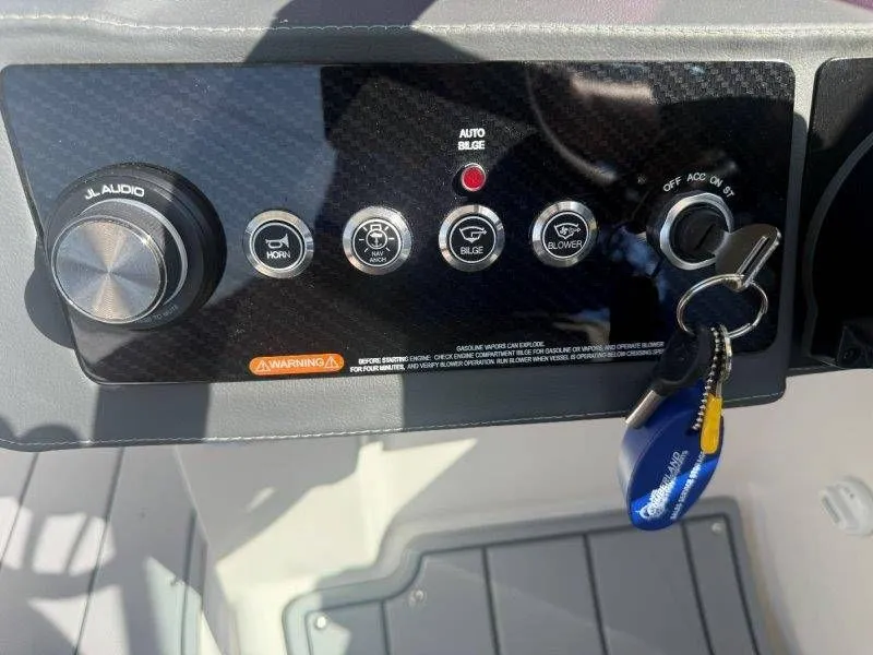 Slide: The Image of Boat dashboard with switches and a key. - 27