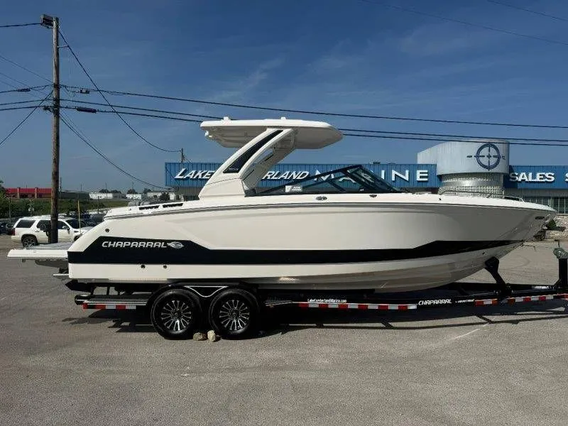 Slide: The Image of 2026 Chaparral SSX 30 on a trailer, parked outdoors at a boat dealership. - 9