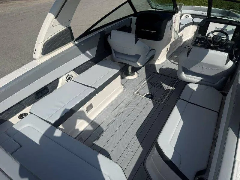 Slide: The Image of Interior view of a modern boat with white seating and gray flooring. - 39