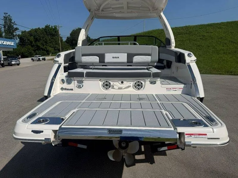 Slide: The Image of Rear view of a Chaparral SSX 30 boat with gray upholstery and speakers. - 14
