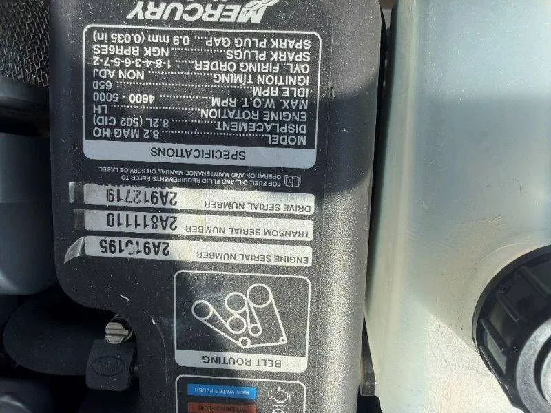 Slide: The Image of Close-up of a boat engine with technical specifications and part numbers. - 34