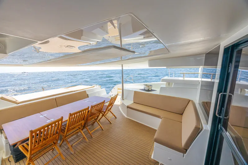 Slide: The Image of Spacious deck of 2015 Fountaine Pajot Sanya 57 catamaran with ocean view and seating area. - 34