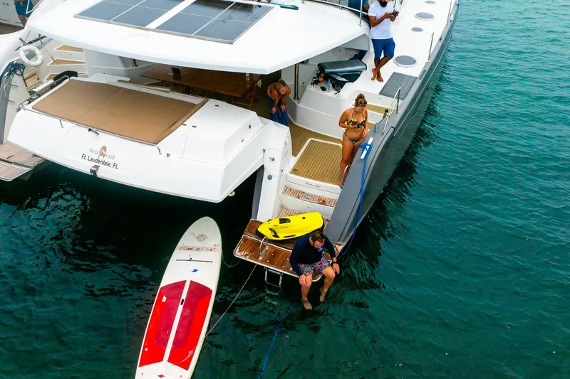 Slide: The Image of 2015 Fountaine Pajot Sanya 57 yacht with people enjoying water activities. - 66