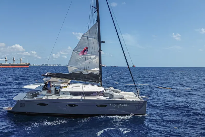 Slide: The Image of 2015 Fountaine Pajot Sanya 57 catamaran sailing on open ocean under clear blue sky. - 50
