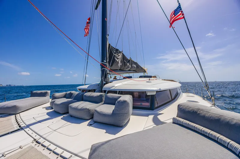 Slide: The Image of Luxurious 2015 Fountaine Pajot Sanya 57 catamaran with plush seating, sailing on open sea. - 39