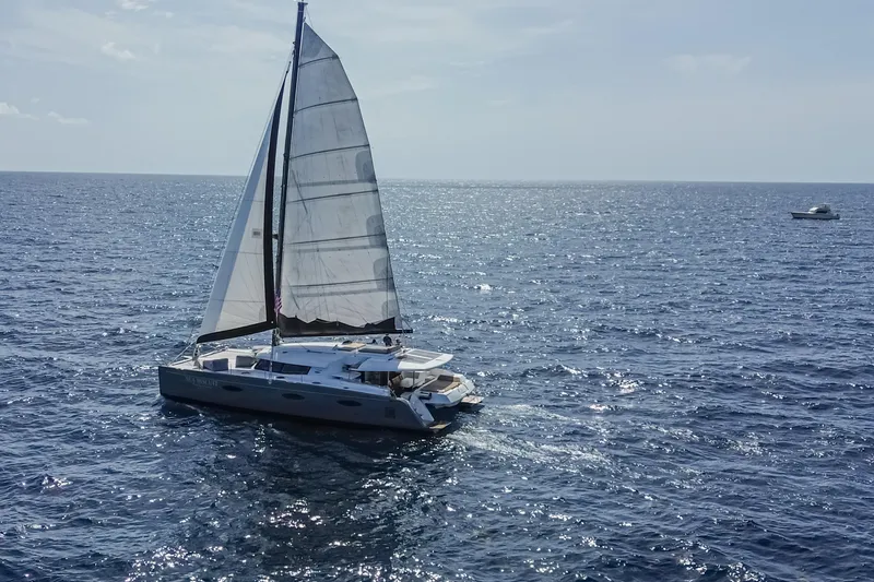 Slide: The Image of Sailing catamaran Fountaine Pajot Sanya 57, 2015 model, gliding on open sea. - 58