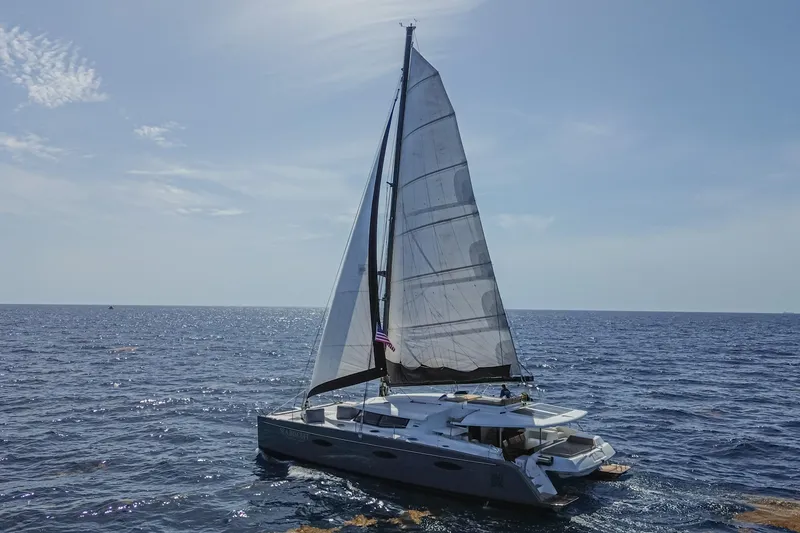 Slide: The Image of 2015 Fountaine Pajot Sanya 57 sailing catamaran on open sea under clear sky. - 52