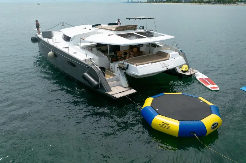 Slide: The Image of Luxury Fountaine Pajot Sanya 57 yacht with water trampoline, 2015 model, anchored at sea. - 65