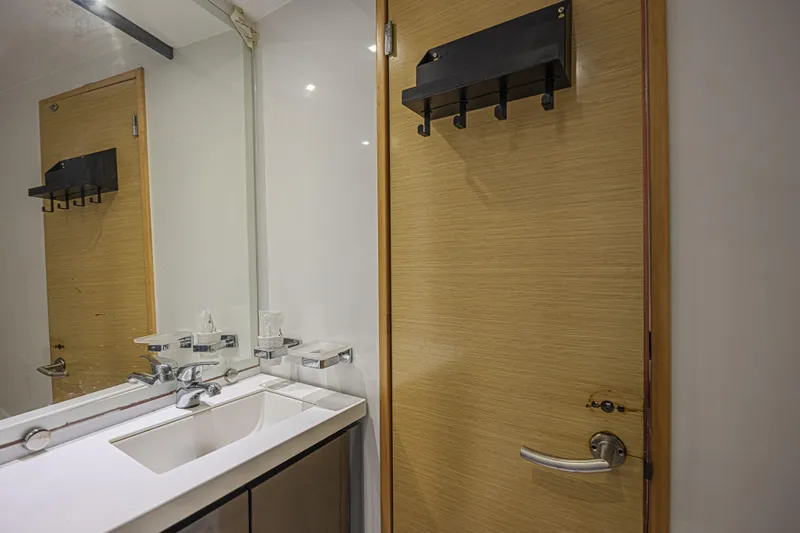 Slide: The Image of Modern bathroom interior on 2015 Fountaine Pajot Sanya 57 yacht, featuring sleek sink and wooden door. - 25