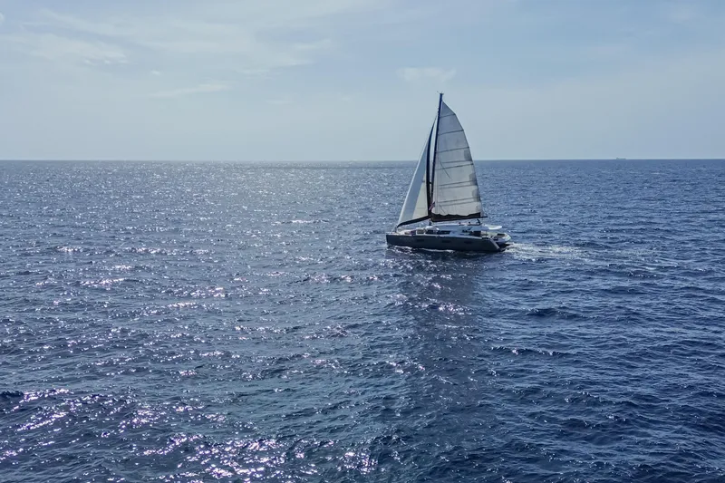 Slide: The Image of Sailing catamaran Fountaine Pajot Sanya 57, 2015, gliding on open sea under clear sky. - 57