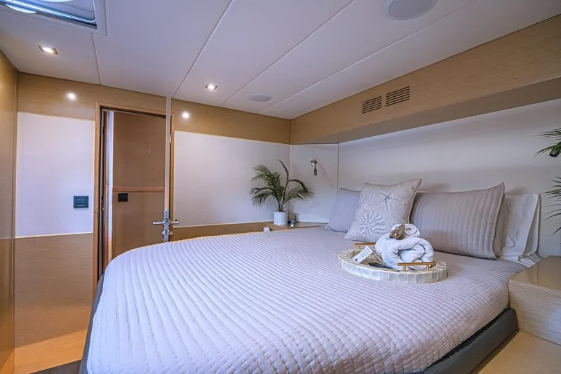 Slide: The Image of Luxurious bedroom interior of 2015 Fountaine Pajot Sanya 57 yacht, featuring elegant bedding and decor. - 23