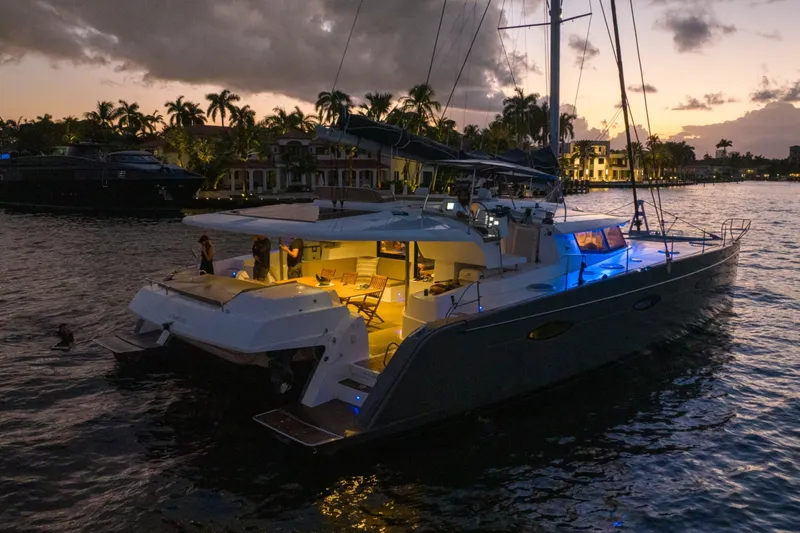Slide: The Image of 2015 Fountaine Pajot Sanya 57 catamaran illuminated at sunset on tranquil waters. - 68