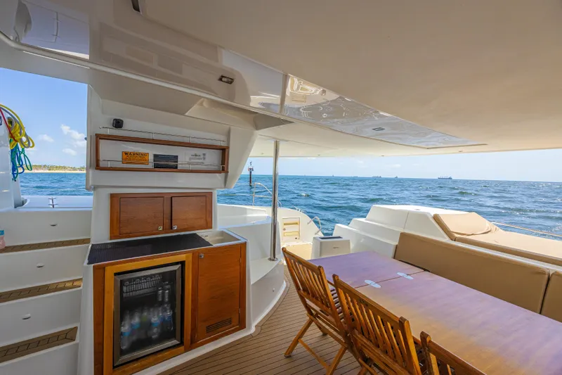 Slide: The Image of Luxurious 2015 Fountaine Pajot Sanya 57 yacht interior with ocean view, featuring dining area and kitchenette. - 35