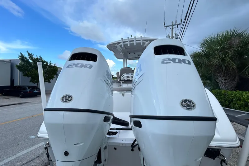 Slide: The Image of 2023 Sea Pro 259 Center Console with twin 200 horsepower engines, parked outdoors. - 3