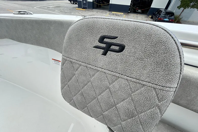 Slide: The Image of 2023 Sea Pro 259 Center Console boat seat with logo and textured upholstery. - 11