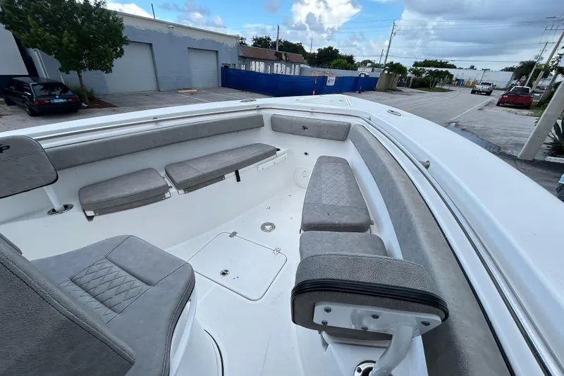 Slide: The Image of 2023 Sea Pro 259 Center Console boat interior with cushioned seating and spacious layout. - 15