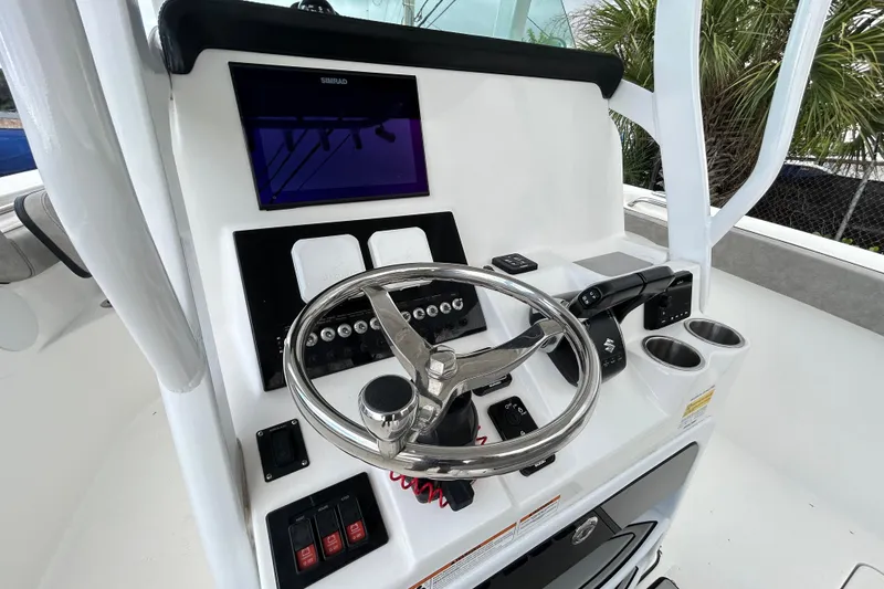 Slide: The Image of 2023 Sea Pro 259 Center Console helm with steering wheel and navigation display. - 7