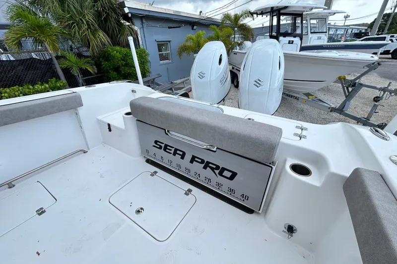 Slide: The Image of 2023 Sea Pro 259 Center Console boat with dual Suzuki engines, docked outdoors. - 19