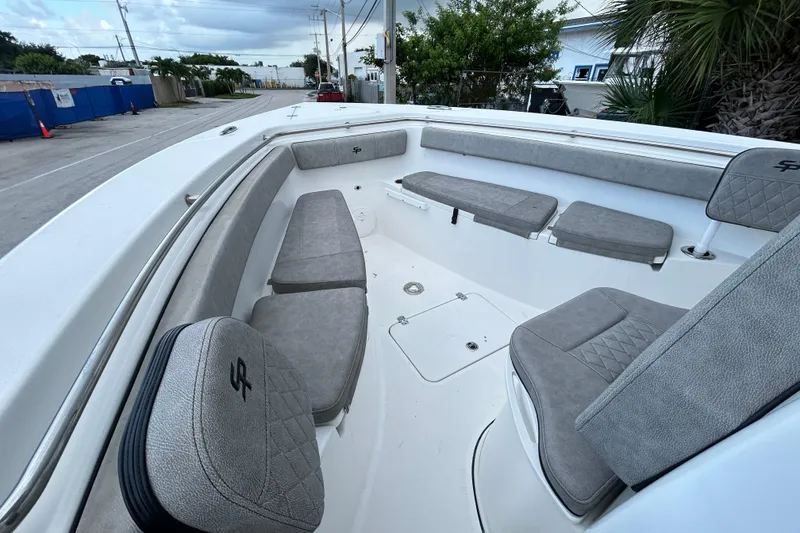 Slide: The Image of 2023 Sea Pro 259 Center Console boat interior with gray cushioned seating. - 10