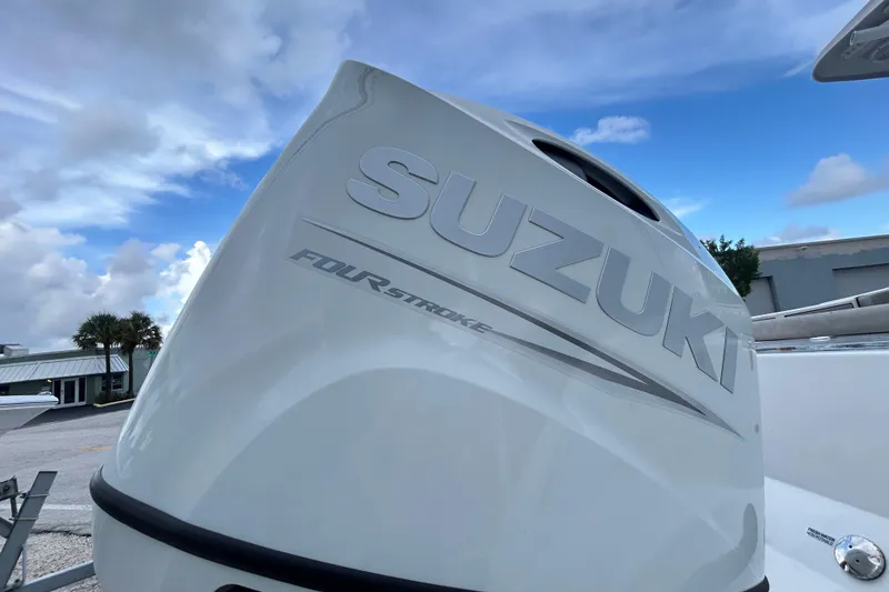 Slide: The Image of Suzuki four-stroke engine on 2023 Sea Pro 259 Center Console boat under blue sky. - 4