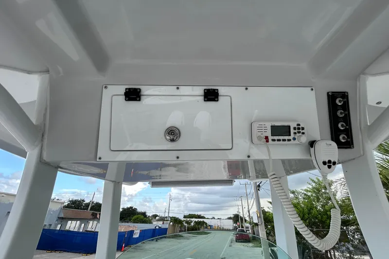 Slide: The Image of 2023 Sea Pro 259 Center Console helm with radio and control panel. - 9
