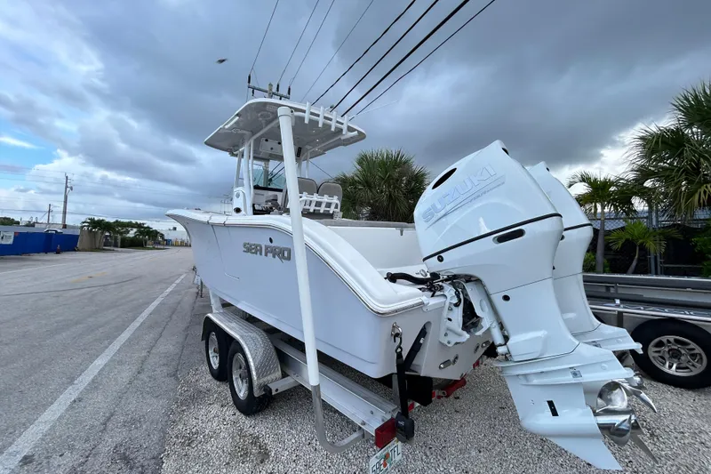 Slide: The Image of 2023 Sea Pro 259 Center Console boat with Suzuki outboard engine on a trailer. - 23