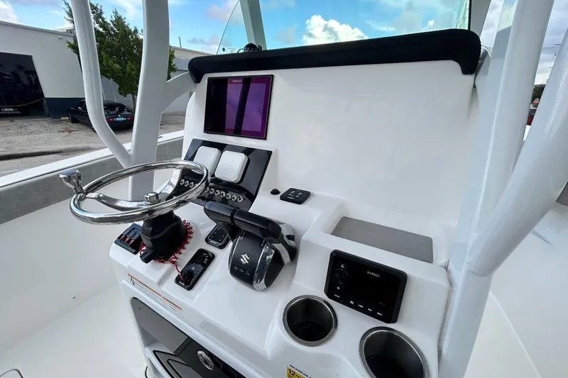 Slide: The Image of 2023 Sea Pro 259 Center Console helm with steering wheel and modern controls. - 6