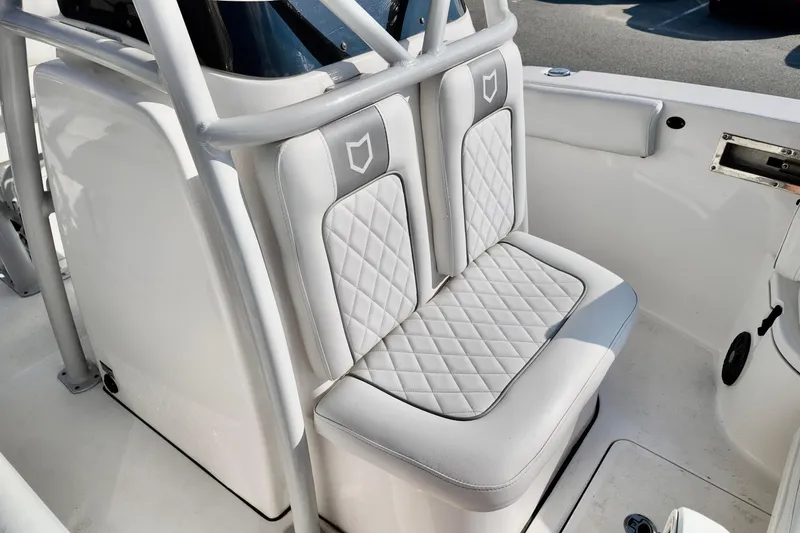 Slide: The Image of 2024 Sea Fox 248 Commander boat with cushioned seating and sleek design. - 21