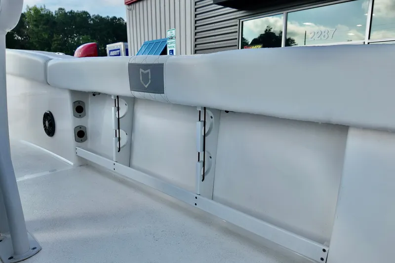 Slide: The Image of 2024 Sea Fox 248 Commander boat interior detail with white cushioned seating and speaker. - 18