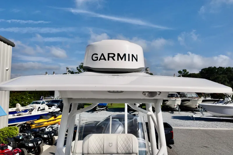 Slide: The Image of 2024 Sea Fox 248 Commander with Garmin radar, parked among other boats under a clear sky. - 22