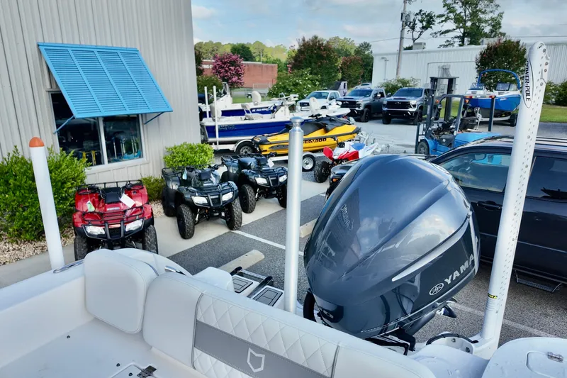 Slide: The Image of 2024 Sea Fox 248 Commander boat with Yamaha engine, surrounded by ATVs and vehicles. - 13
