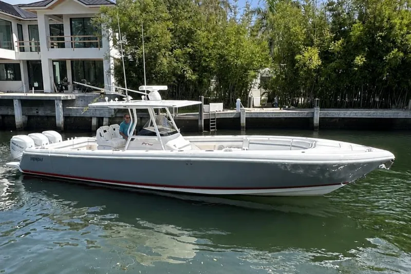 The Image of 2013 Intrepid 375 Center Console boat docked near waterfront home. - 0