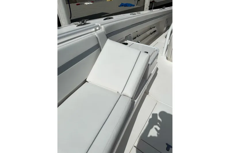 Slide: The Image of 2013 Intrepid 375 Center Console boat with white cushioned seating. - 10