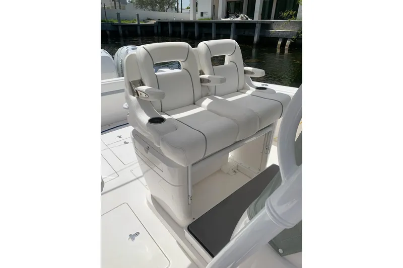 Slide: The Image of 2013 Intrepid 375 Center Console boat with dual white cushioned seats and armrests. - 7