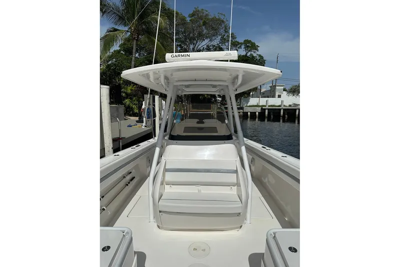 Slide: The Image of 2013 Intrepid 375 Center Console boat with Garmin equipment, docked by a waterfront. - 9