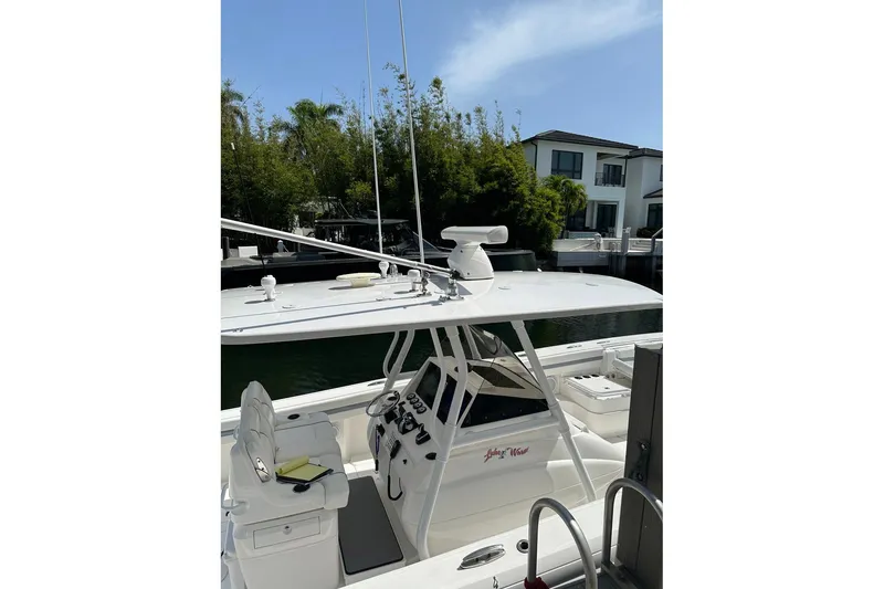 Slide: The Image of 2013 Intrepid 375 Center Console boat docked near waterfront homes. - 17