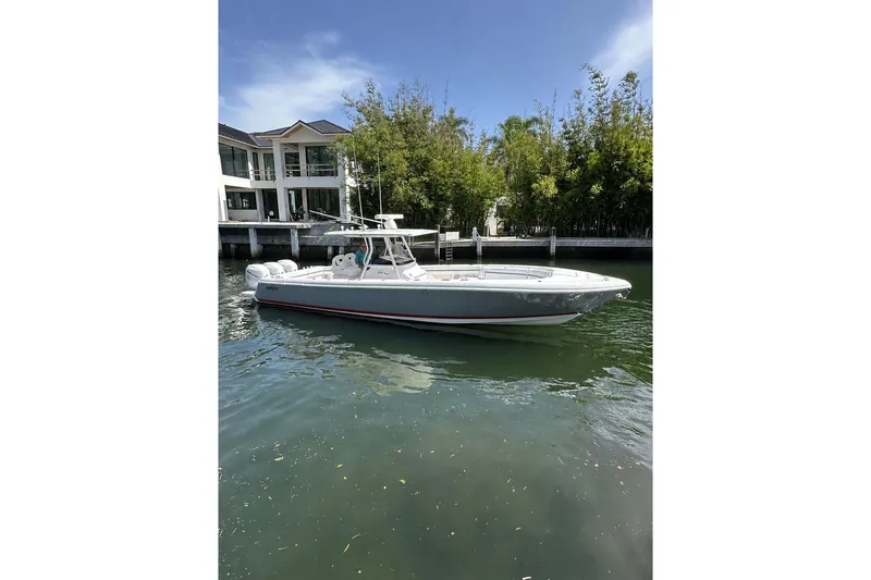 The Image of 2013 Intrepid 375 Center Console boat docked near waterfront home. - 0