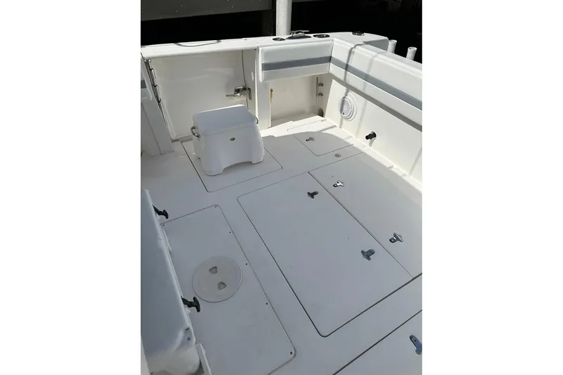 Slide: The Image of 2013 Intrepid 375 Center Console boat deck with storage compartments and seating. - 6
