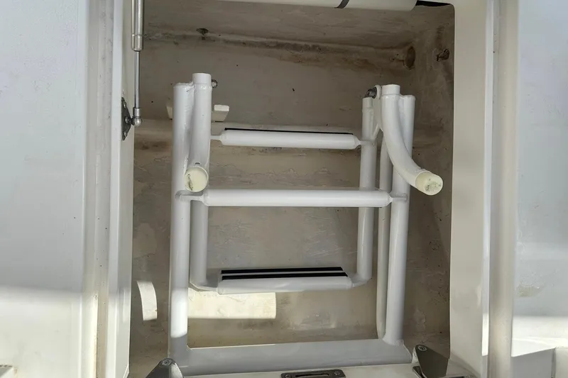 Slide: The Image of Foldable ladder in storage compartment of 2013 Intrepid 375 Center Console boat. - 25